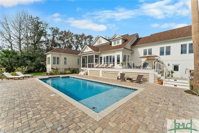 back of house featuring a patio and a sunroom