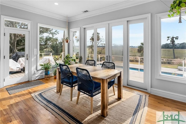 sunroom featuring plenty of natural light and french doors