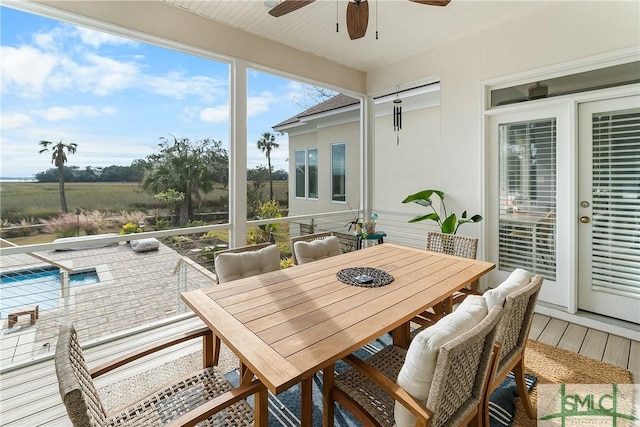 sunroom / solarium featuring ceiling fan