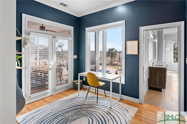 office space with wood-type flooring, ornamental molding, and ceiling fan