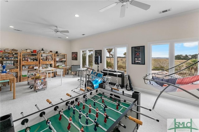 game room with crown molding, ceiling fan, and carpet