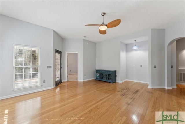 unfurnished living room featuring hardwood / wood-style floors, a textured ceiling, and ceiling fan