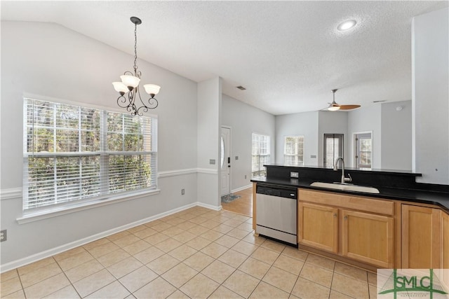 kitchen with sink, light tile patterned floors, dishwasher, hanging light fixtures, and vaulted ceiling