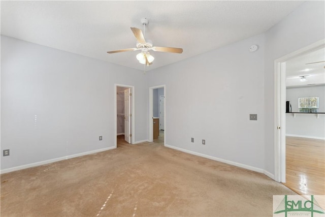 carpeted empty room featuring ceiling fan