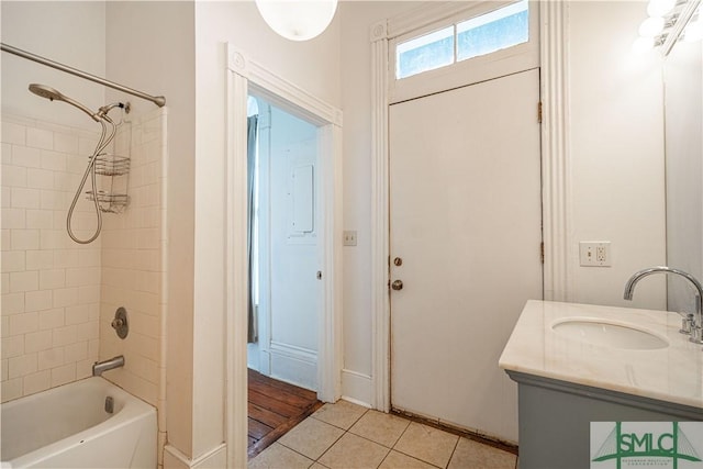 bathroom featuring tile patterned floors, vanity, and tiled shower / bath combo