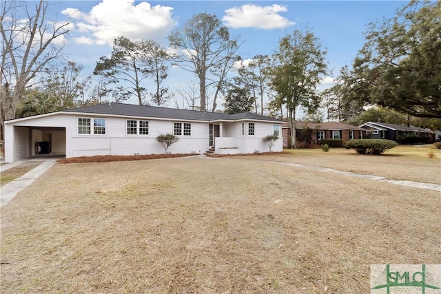 single story home featuring a front yard and a carport