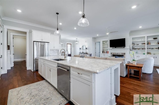 kitchen featuring a kitchen island with sink, stainless steel appliances, and white cabinets