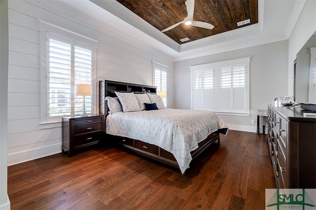 bedroom featuring multiple windows, wood ceiling, dark hardwood / wood-style floors, and a raised ceiling