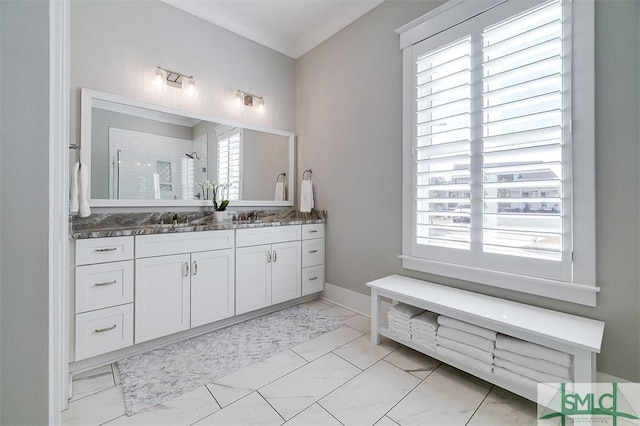 bathroom with walk in shower, vanity, and a wealth of natural light