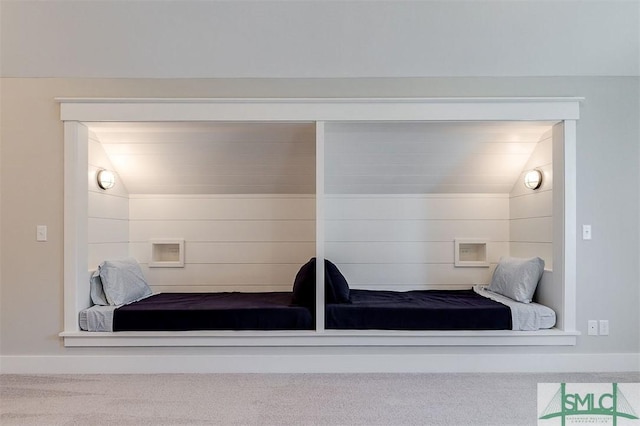 carpeted bedroom with lofted ceiling