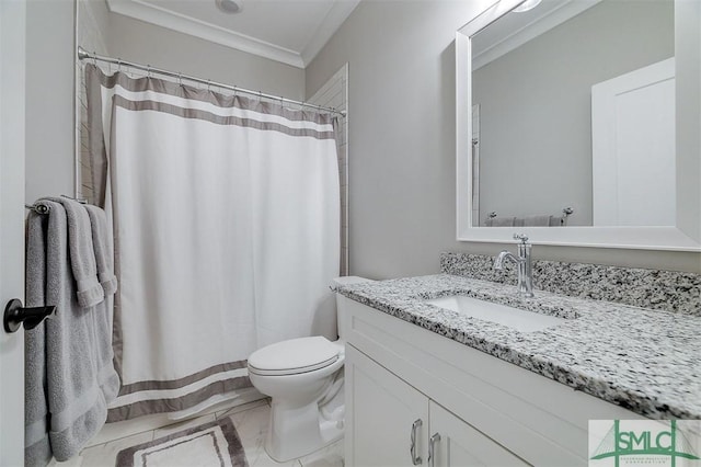 bathroom with ornamental molding, vanity, and toilet