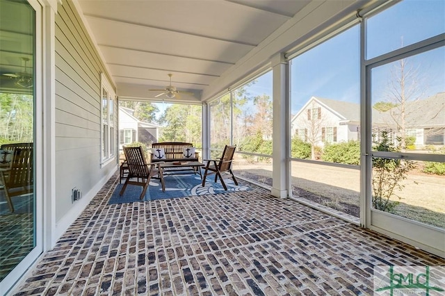 sunroom / solarium featuring ceiling fan and a healthy amount of sunlight