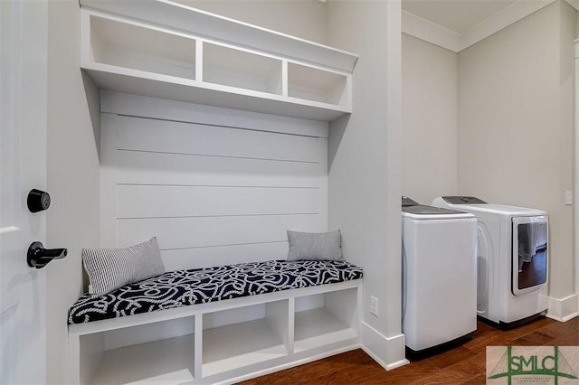 mudroom with dark wood-type flooring and independent washer and dryer