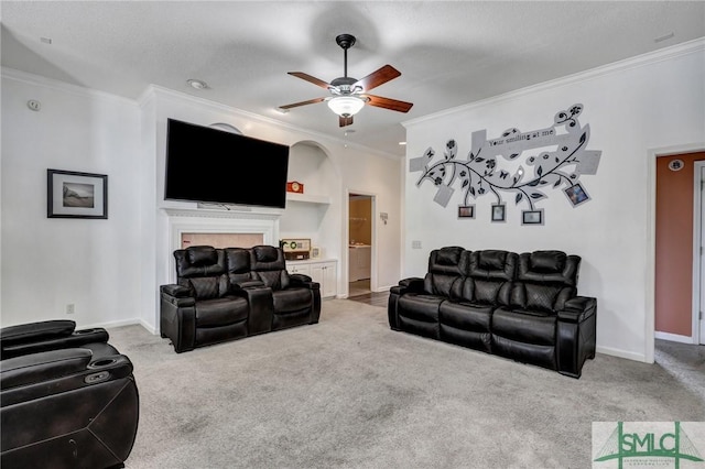 carpeted living room with crown molding and ceiling fan