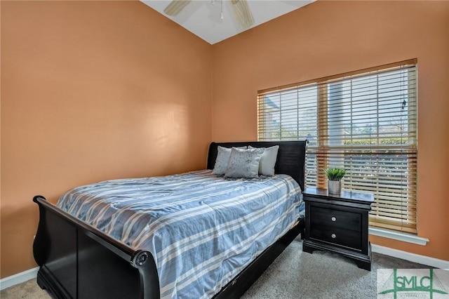 carpeted bedroom with vaulted ceiling and ceiling fan