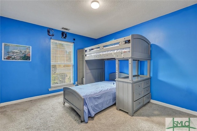 carpeted bedroom with a textured ceiling