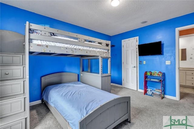 bedroom featuring a textured ceiling and carpet flooring