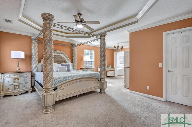 bedroom featuring a textured ceiling, ornamental molding, carpet flooring, a tray ceiling, and decorative columns