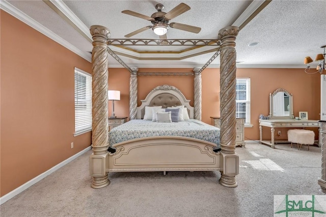 bedroom with crown molding, a raised ceiling, carpet floors, and a textured ceiling