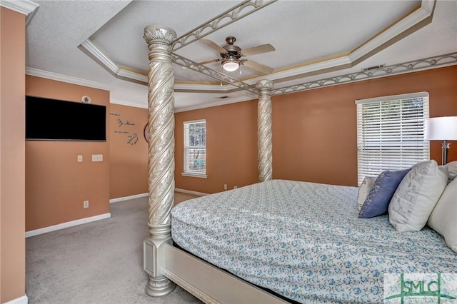 bedroom with ornate columns, crown molding, a textured ceiling, a tray ceiling, and carpet