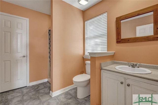 bathroom featuring vanity and toilet