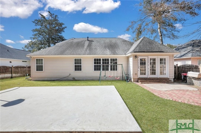 back of property featuring french doors, a patio, and a lawn