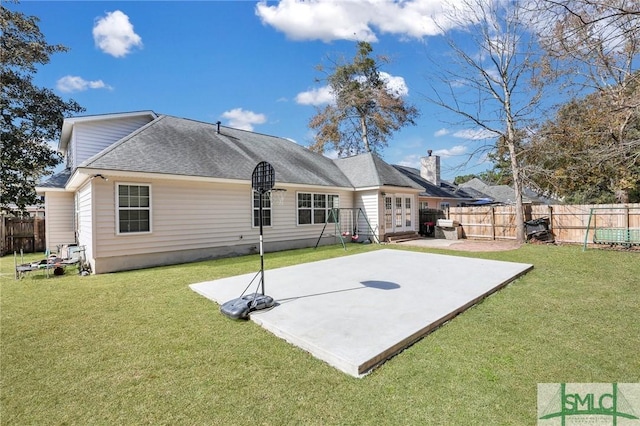 rear view of property featuring a lawn and a patio area