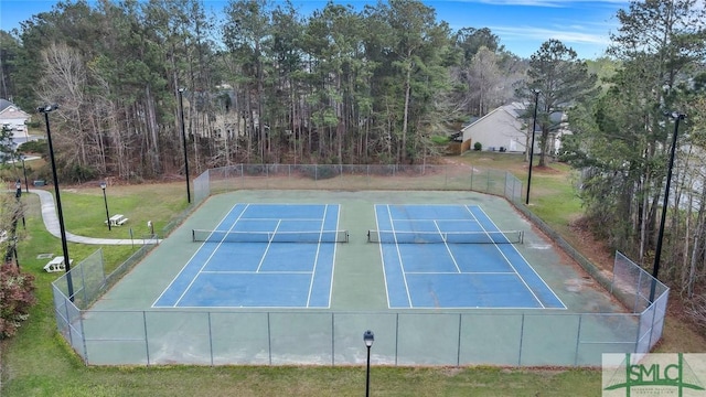 view of sport court with a yard