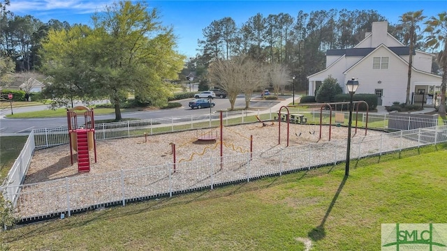 view of property's community with a playground and a lawn