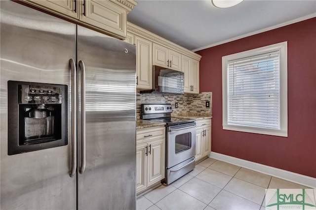 kitchen featuring backsplash, stainless steel appliances, cream cabinets, light stone countertops, and light tile patterned flooring