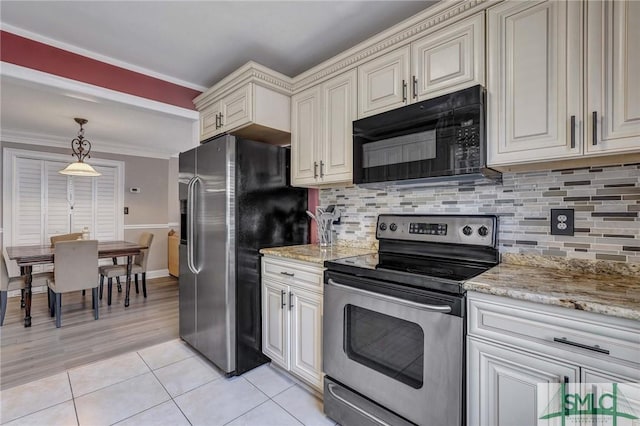 kitchen featuring light tile patterned floors, decorative light fixtures, cream cabinets, and stainless steel appliances