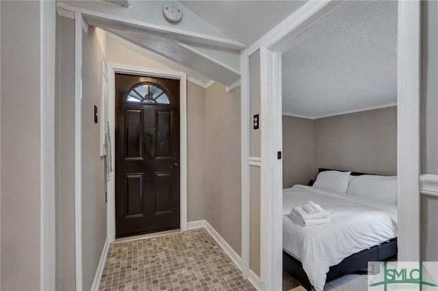 entrance foyer featuring lofted ceiling and ornamental molding