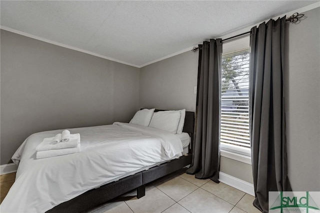 bedroom with crown molding, light tile patterned floors, and a textured ceiling