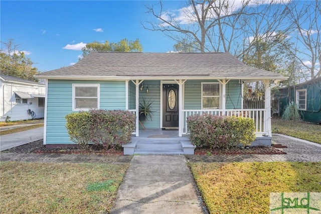 bungalow-style house with a porch and a front yard