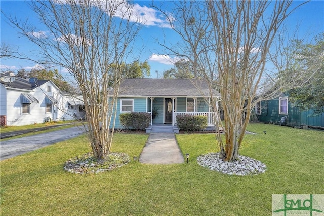 single story home featuring covered porch and a front yard