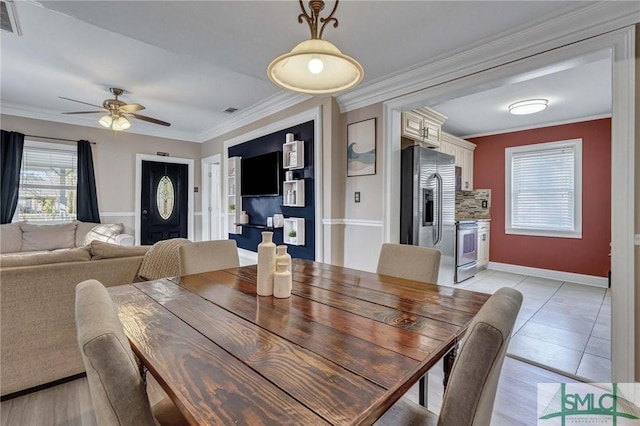 dining area with ornamental molding and ceiling fan