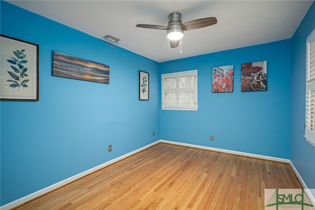 empty room featuring hardwood / wood-style floors and ceiling fan