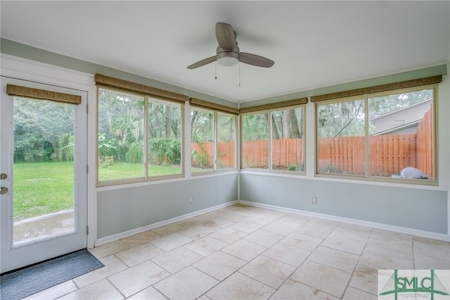 unfurnished sunroom featuring plenty of natural light and ceiling fan