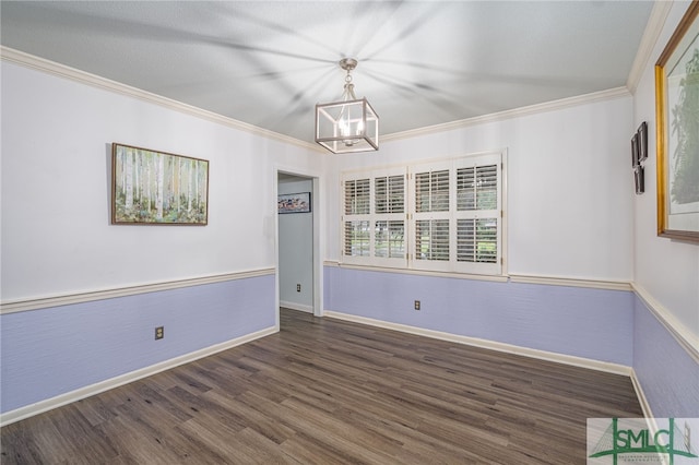 unfurnished room with a notable chandelier, ornamental molding, and dark hardwood / wood-style floors