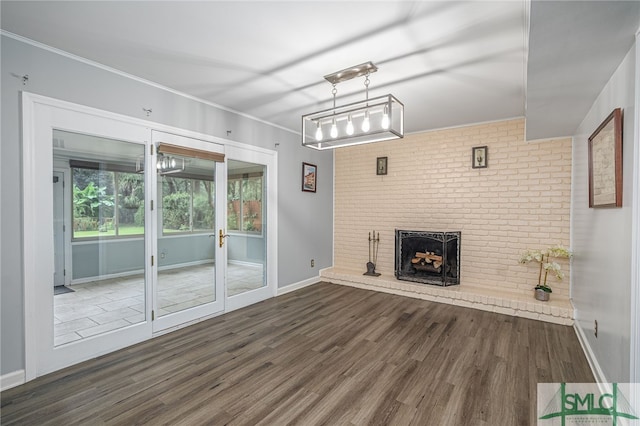 unfurnished living room with ornamental molding, a fireplace, and dark hardwood / wood-style flooring