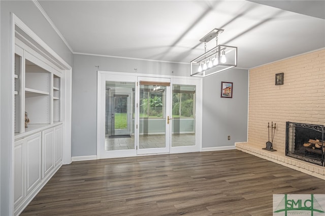 unfurnished living room featuring a fireplace, ornamental molding, and dark hardwood / wood-style flooring