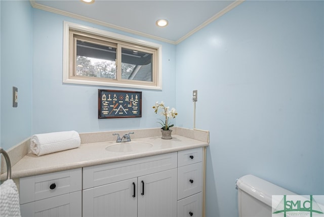 bathroom featuring vanity, ornamental molding, and toilet