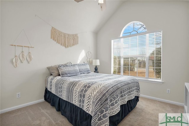 carpeted bedroom with multiple windows, vaulted ceiling, and ceiling fan