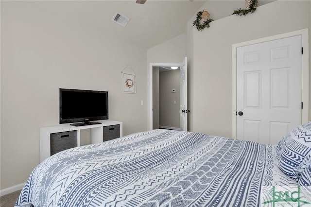 carpeted bedroom with lofted ceiling