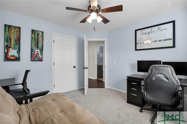 carpeted office featuring ceiling fan