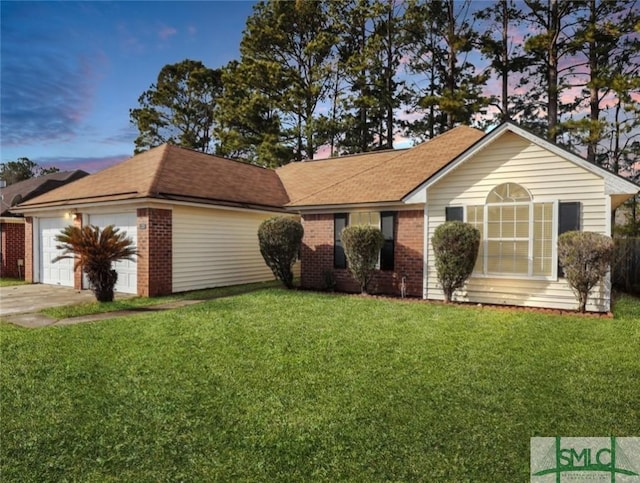 ranch-style home featuring a yard and a garage