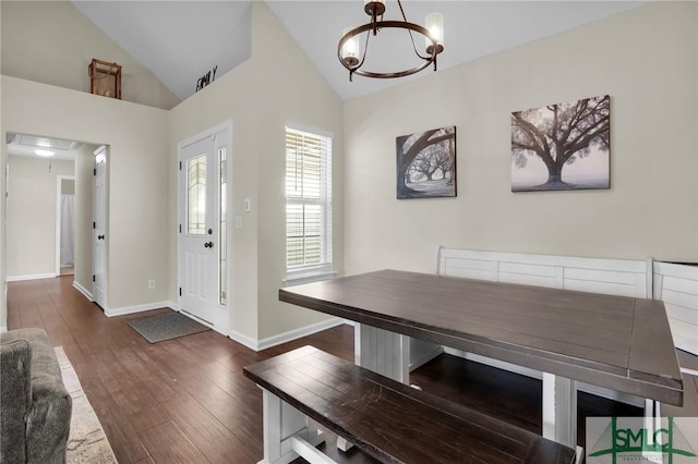 unfurnished dining area featuring dark wood-type flooring, a chandelier, and vaulted ceiling