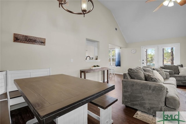 dining room with high vaulted ceiling, dark hardwood / wood-style floors, and ceiling fan