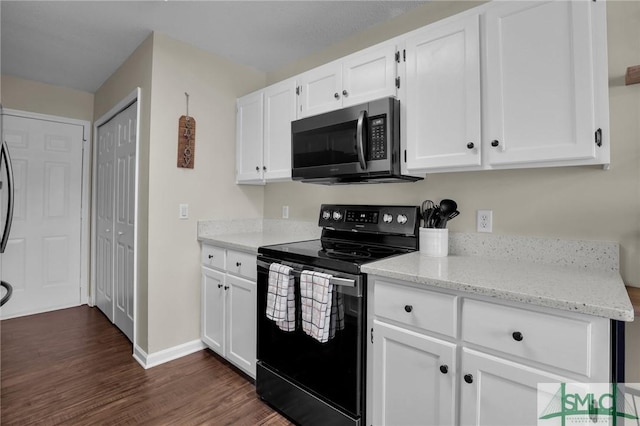 kitchen featuring light stone counters, dark hardwood / wood-style floors, black electric range, and white cabinets