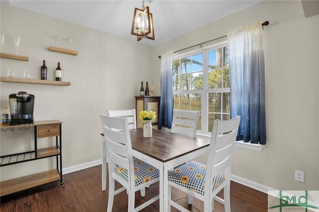 dining room with a notable chandelier and dark hardwood / wood-style floors